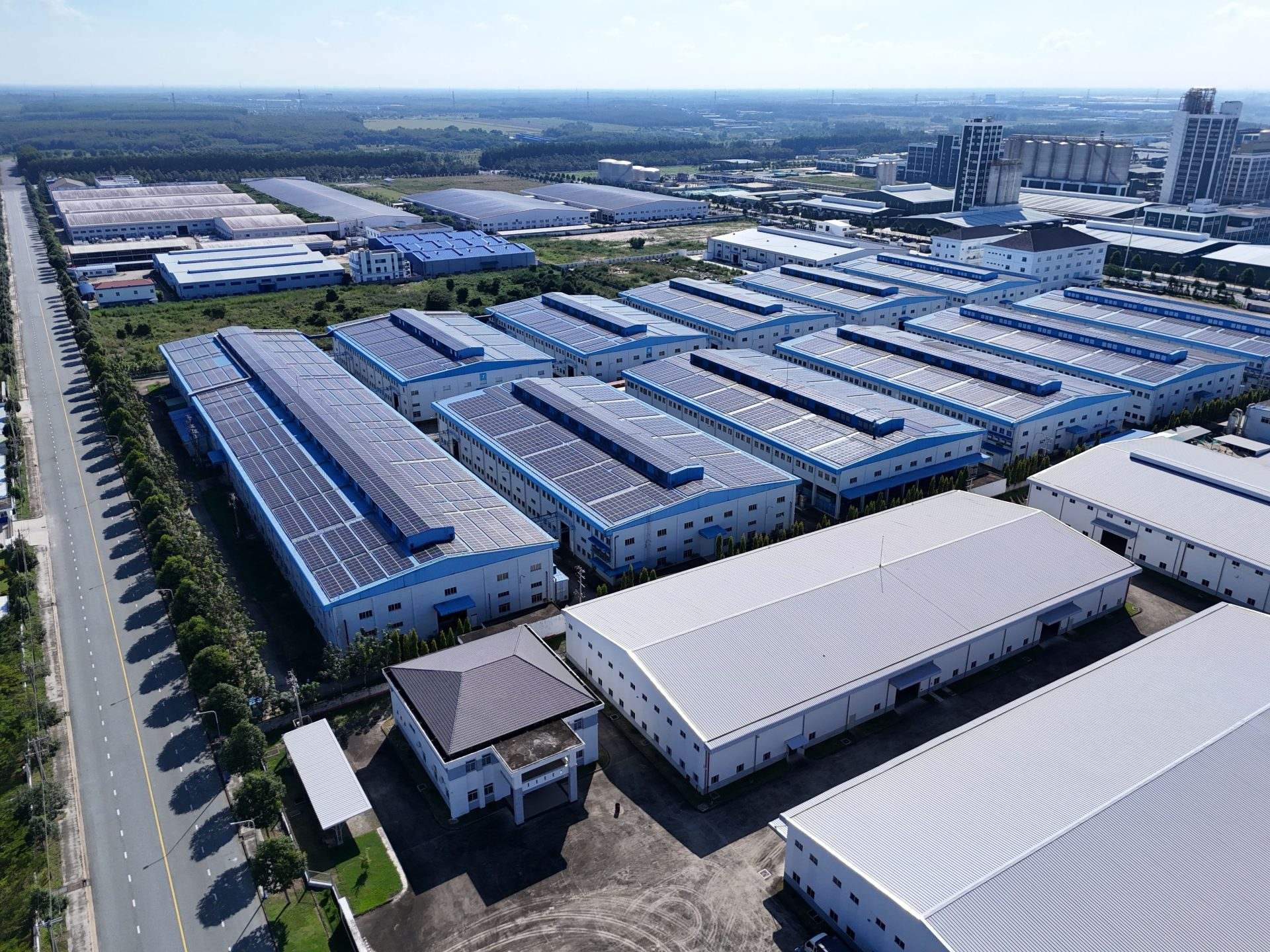 Aerial view of industrial buildings in Thành phố Thủ Dầu Một, Bình Dương, showcasing extensive solar panels.