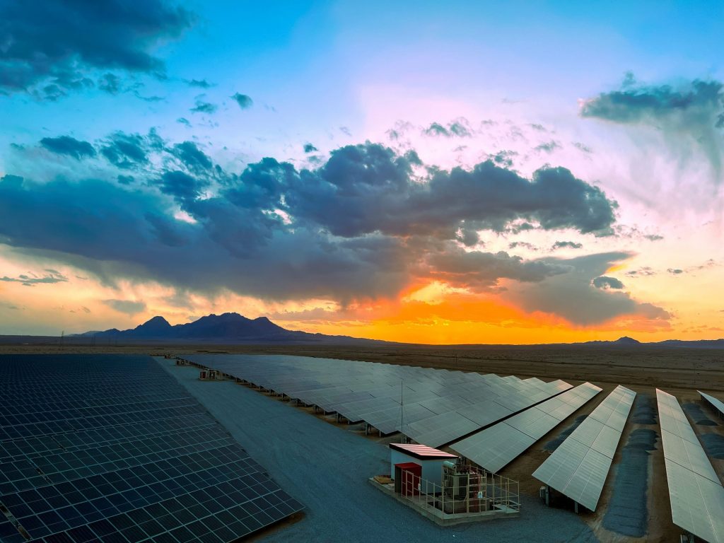 a large array of solar panels in a desert