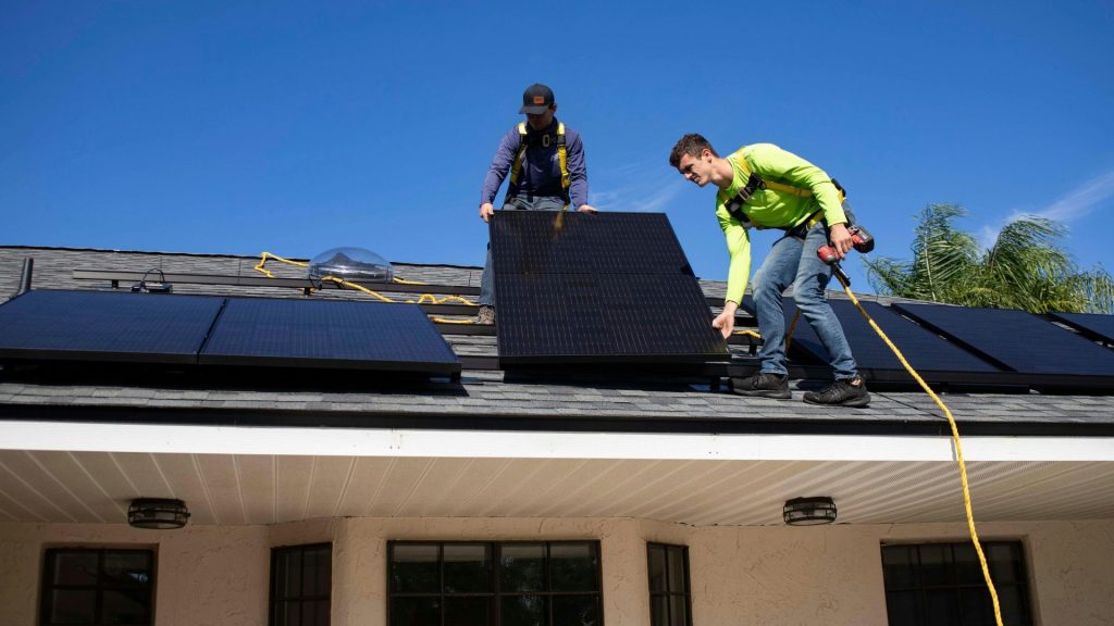 men on top of a roof
